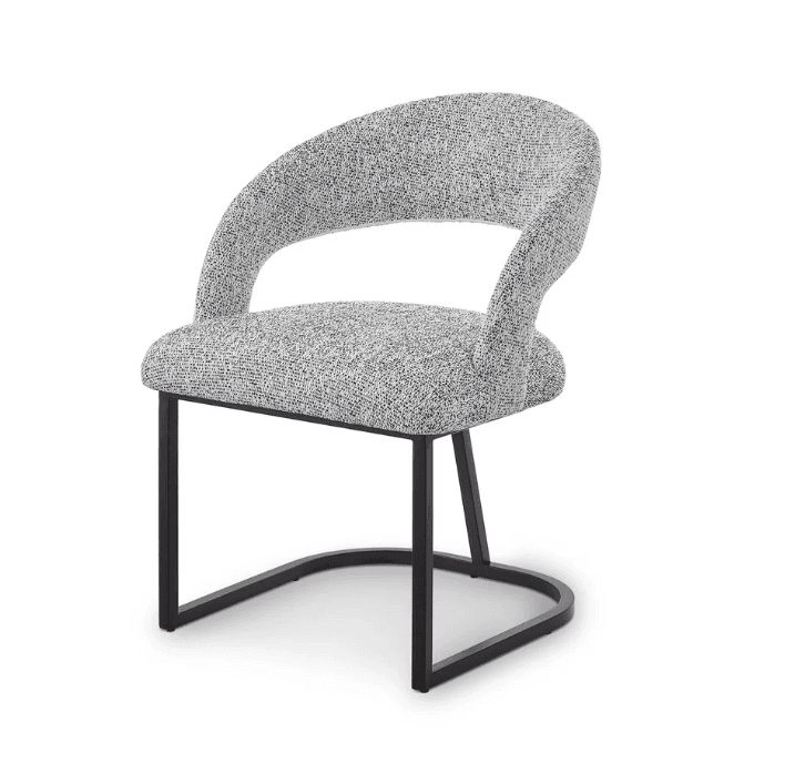 A modern accent chair with a curved silhouette. The seat and back are upholstered in a textured fabric with a speckled grey and white pattern. The base consists of a sled-style frame made of dark metal, featuring a curved front support. — 3D model