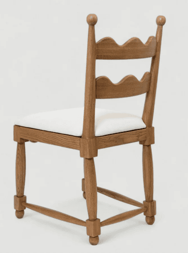 A wooden side chair with a cushioned seat, presented in a side profile against a plain background. The chair features a wooden frame with turned legs and stretchers. The backrest is composed of vertical wooden slats with decorative spherical finials at the top. The seat is upholstered in white fabric. — 3D model