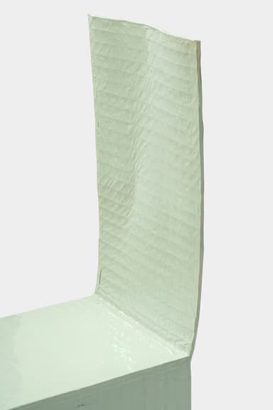 A minimalist chair with a high, straight back and a solid seat. The chair appears to be constructed from a moldable material, possibly resin or fiberglass, with a matte finish. It has a unique, almost monolithic form, with the seat and back merging seamlessly into the legs. A dark rod or dowel connects the two front legs, providing structural support. The overall aesthetic is simple and modern. — 3D model