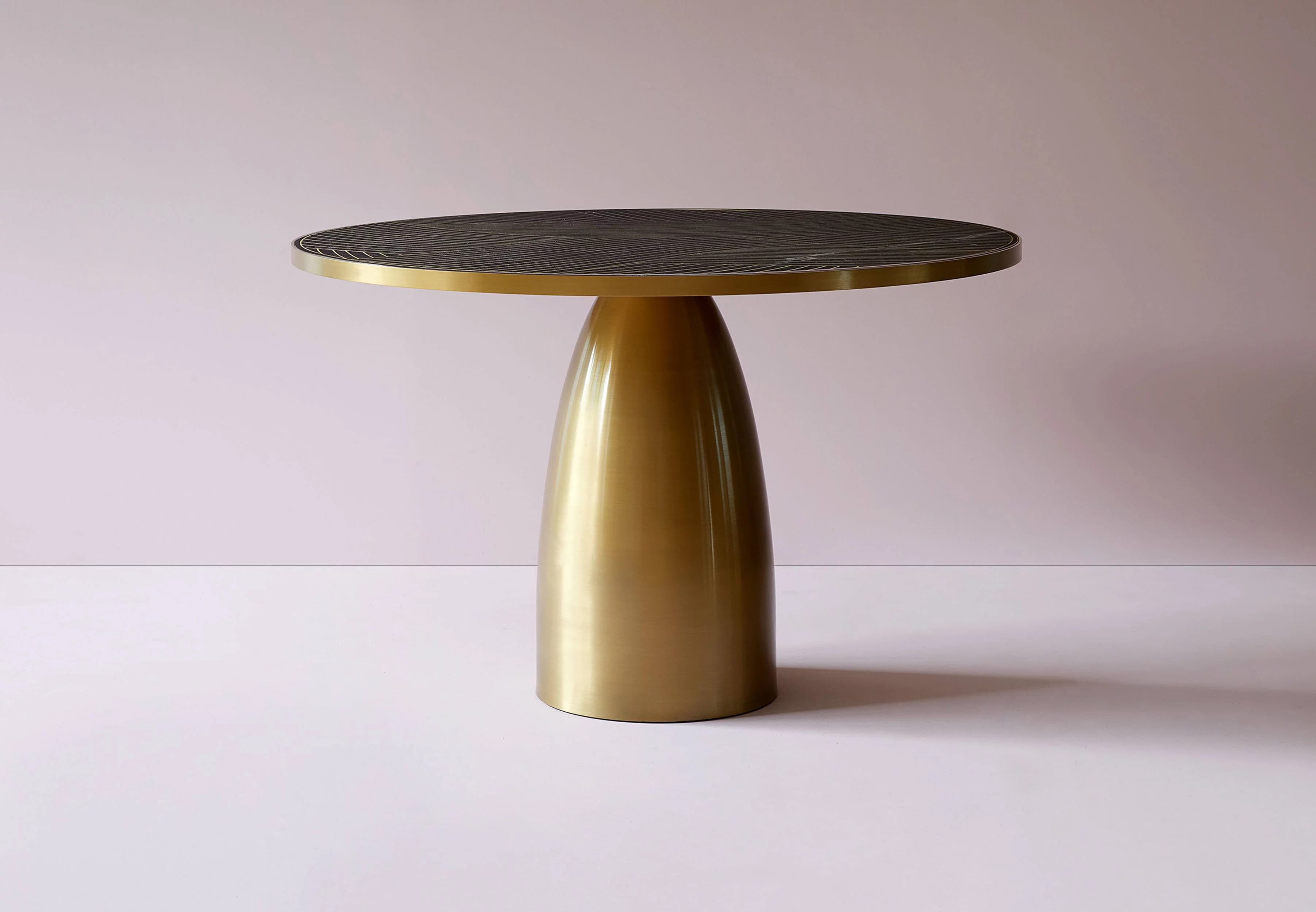 A contemporary side table with a circular top and a single, fluted pedestal base. The tabletop is dark with a pattern of thin, parallel lines and appears to be made of stone or a composite material. The pedestal base is metallic and has a smooth, polished finish. — 3D model