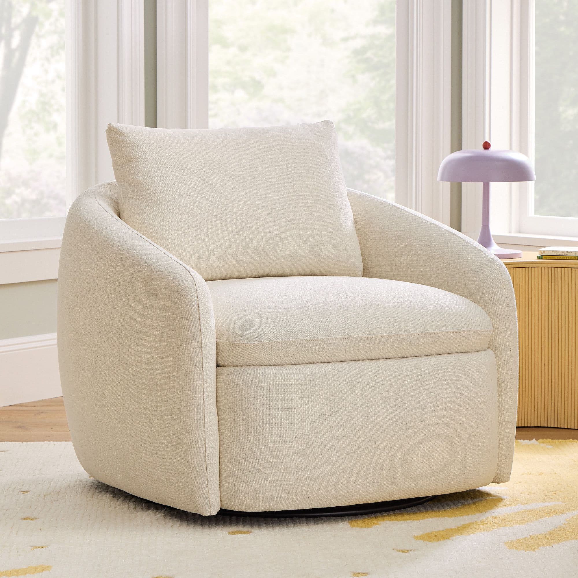 A cream-colored armchair with a rounded silhouette and a plush back cushion. The armchair appears to be upholstered in a textured fabric and sits on a dark-colored swivel base. — 3D model