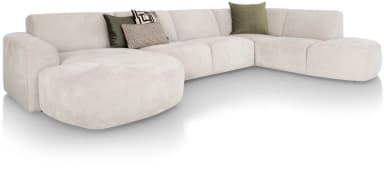 A sectional sofa, viewed from the rear, configured in an L-shape. It features a light beige upholstery with a textured finish. The sofa has a modular design with distinct cushioned sections. The backrests are low and straight, with visible stitching indicating the panel construction. The armrests are slightly rounded and integrated into the main body of the sofa. The base is low to the ground and appears to have small, dark feet. — 3D model