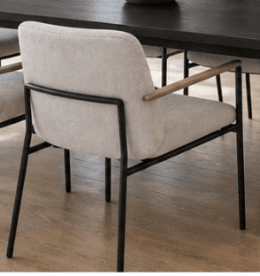 A modern armchair featuring a light-colored upholstered seat and backrest, supported by a slender black metal frame. The armrests are accented with natural light wood caps. The chair has a minimalist and contemporary design. — 3D model