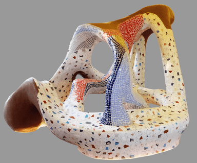 A highly sculptural, organic, and irregularly shaped seating object, primarily covered in a multi-colored terrazzo-style mosaic, with sections featuring finer, patterned mosaic tiles in red, blue, and light purple. The structure includes various openings and undulating surfaces. — 3D model