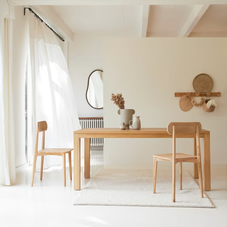 An image displaying a simple, modern dining table crafted from light-toned wood, accompanied by a single matching wooden chair, both set against a plain white background. — 3D model