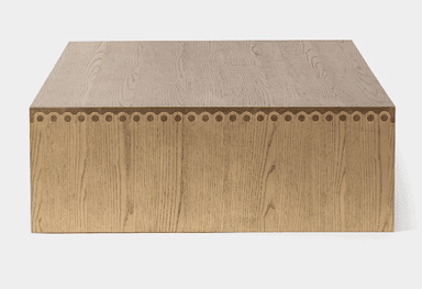 A rectangular coffee table constructed entirely from light-colored solid wood, featuring a minimalist slab design. The tabletop and legs form a continuous, block-like structure with visible wood grain. — 3D model