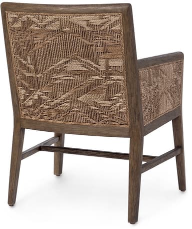 A modern armchair featuring a wooden frame with a distressed dark wood finish. The seat and back are upholstered in a textured white fabric. The armrests have woven panels on the sides, adding a natural element. The chair has four legs connected by stretchers for stability. — 3D model