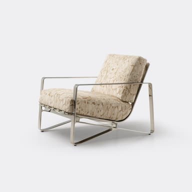 A modern lounge chair featuring a polished metal frame with integrated armrests and supportive back webbing, complemented by thick upholstered cushions in a beige and brown geometric pattern. — 3D model