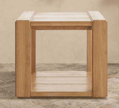 A detailed close-up shot of the corner of a two-tiered console table constructed from light-toned natural wood. The top surface features a framed design with parallel wooden planks. Directly below, a second shelf is visible, also made of parallel wooden planks, creating a functional two-tiered structure. The table leg is stout and rectangular, connected to the top and lower shelf with visible joinery, suggesting a sturdy construction. The wood exhibits a fine, consistent grain with a light, natural finish. — 3D model
