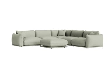 A light sage green modular sectional sofa featuring a low-profile base and plush, rounded upholstered cushions. The sofa is arranged in an L-shape configuration, accompanied by a matching square ottoman placed in front. The design emphasizes comfort and a minimalist contemporary aesthetic, with soft lines and a cohesive color palette. — 3D model