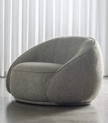 A contemporary lounge chair featuring a soft, rounded, and inviting silhouette, fully upholstered in a textured grey fabric. The chair has a low profile with integrated armrests and backrest forming a continuous, curving shell. — 3D model