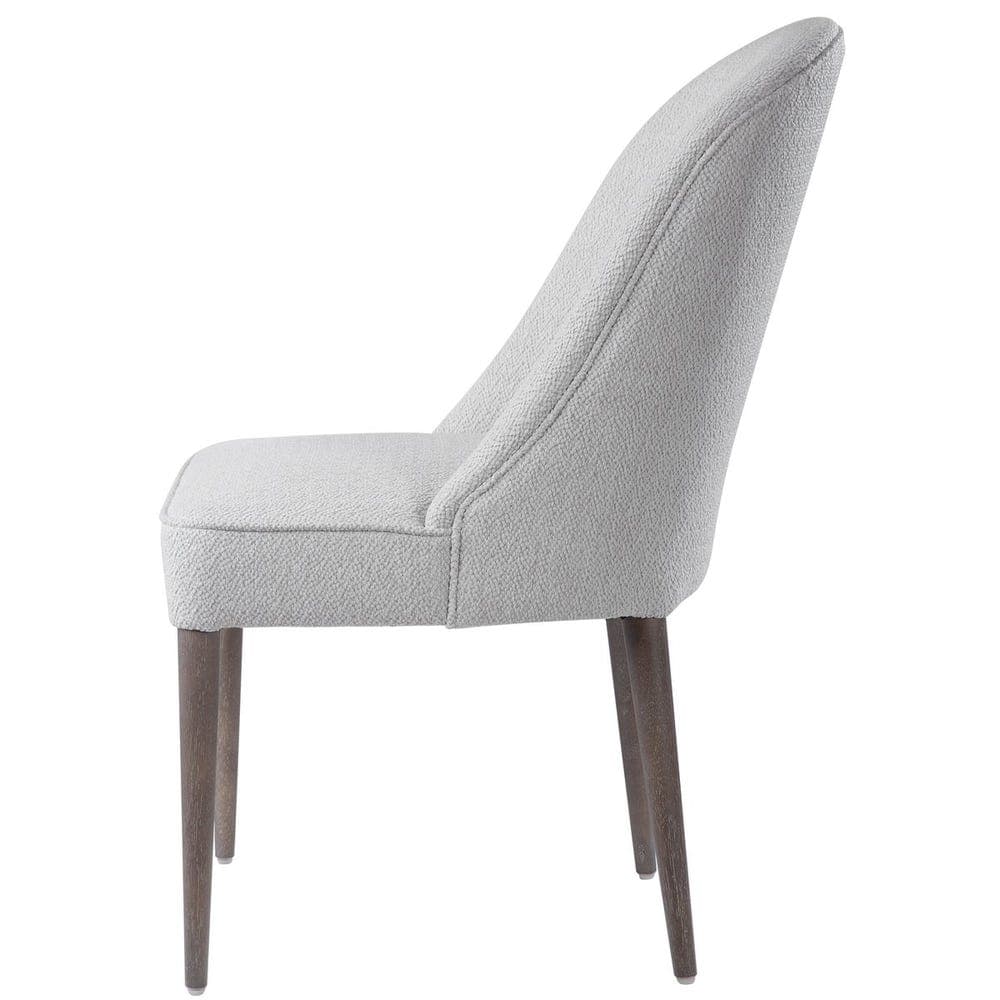 An armless upholstered dining chair featuring a gracefully curved high backrest and a fully cushioned seat, both covered in a light gray textured fabric. The chair is supported by four slender, tapered wooden legs with a dark, possibly walnut or espresso, finish. Its minimalist design and neutral color palette suggest a contemporary or transitional aesthetic. — 3D model
