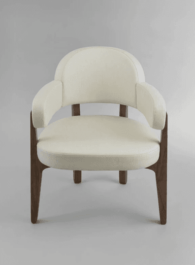 A contemporary armchair featuring an upholstered seat, backrest, and integrated armrests, all in a light, neutral fabric. The frame and legs are constructed from solid dark wood, likely walnut, with a smooth, tapered design. The chair exhibits clean lines and a comfortable, inviting aesthetic suitable for various modern interiors. — 3D model