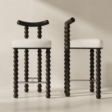 A bar stool with a dark wood frame and a light-colored upholstered seat. The frame features turned wooden legs with a series of rounded protrusions, giving it a distinctive bobbin or spindle design. The backrest is curved and made of the same dark wood. A metal footrest connects the front legs. — 3D model