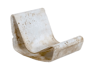 A sculptural lounge chair, likely made from a single piece of molded fiberglass or a similar composite material. It features a continuous, curved form that provides both the seat and backrest. The material is light-colored, possibly off-white, and shows significant signs of wear, discoloration, and potential staining, suggesting age or prolonged outdoor exposure. The design is minimalist and organic. — 3D model