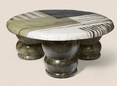 A low-profile coffee table with an oval, irregularly shaped top. The tabletop is segmented with various abstract patterns and stripes in earthy tones and black and white. The base consists of three bulbous, stacked pedestal-like legs, each with a segmented, bulbous form, finished in a dark, textured, glossy material. — 3D model