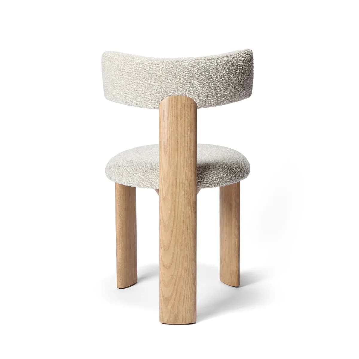 A modern dining chair featuring a rounded, off-white boucle upholstered seat and a crescent-shaped backrest, supported by four thick, light-toned cylindrical wooden legs. — 3D model