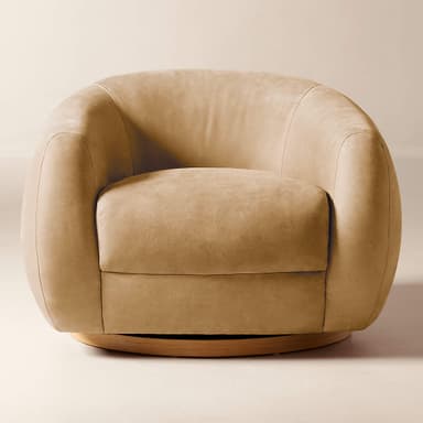 A contemporary armchair with a rounded, barrel-shaped silhouette. It features a low-profile design with generously padded upholstery and a swivel base. The base is a circular wooden platform, likely designed for 360-degree rotation. The overall form is soft and inviting, with seamless upholstery transitions. — 3D model