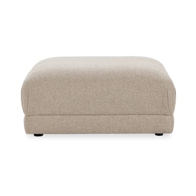 A rectangular ottoman with softly rounded corners, upholstered in a textured, woven fabric. The ottoman has a low profile and appears to be well-padded. It is supported by four small, dark-colored feet, barely visible beneath the base. — 3D model