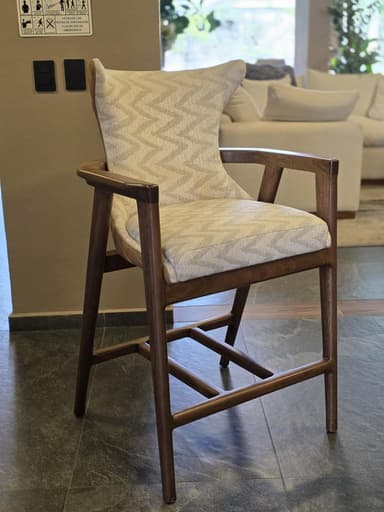 A contemporary counter-height armchair featuring a dark wood frame and fully upholstered seat and back. The upholstery showcases a distinctive beige zig-zag pattern. — 3D model