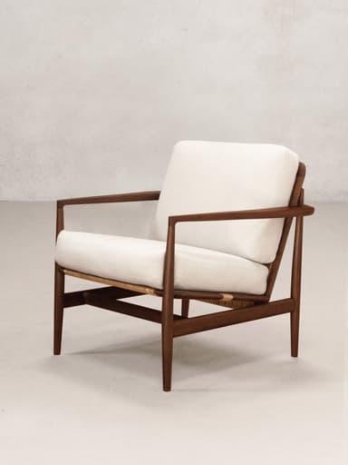 A mid-century modern lounge chair featuring a dark wooden frame and light-colored upholstered cushions. The design is characterized by clean lines and exposed joinery, with a slightly reclined posture for relaxation. — 3D model