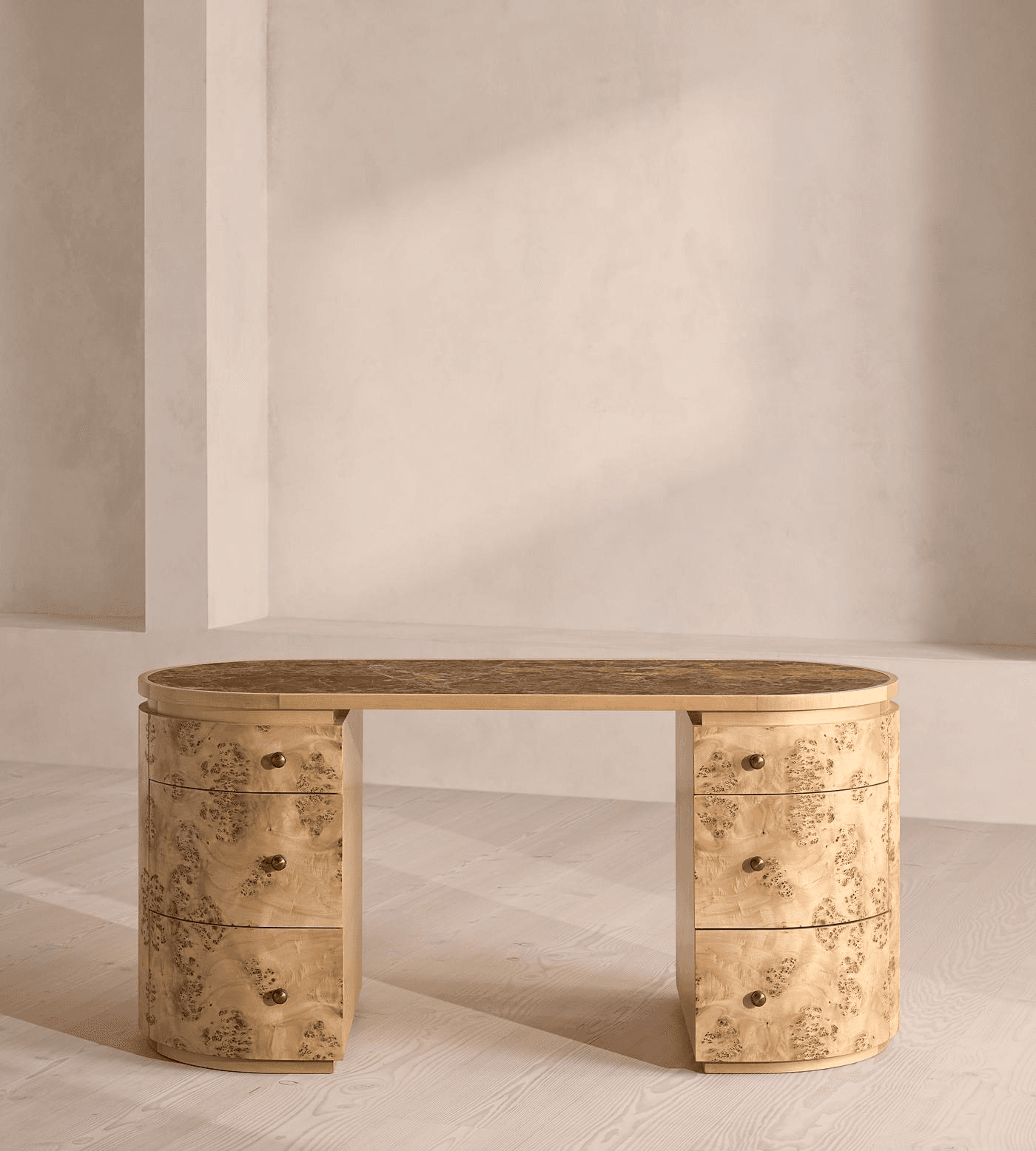 An elegant Art Deco-inspired writing desk featuring an oval tabletop with a dark, textured surface, supported by two rounded pedestals. Each pedestal houses multiple drawers, finished in a distinctive burl wood veneer with brass knob pulls. The design emphasizes curvilinear forms and luxurious materials. — 3D model