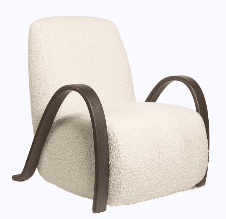 An armchair with a cream-colored, textured upholstery and curved, dark wood armrests. The chair has a rounded silhouette for the seat and back, with the wooden armrests gracefully curving from the base to the sides of the seat. The upholstery appears to be a boucle or similar textured fabric. — 3D model