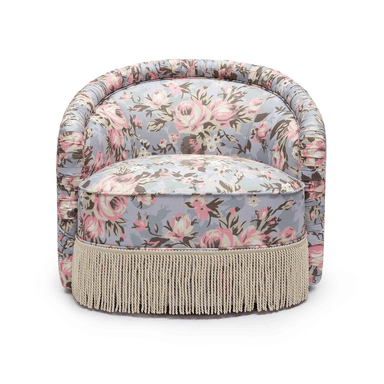 A small, fully upholstered barrel-back accent chair featuring a vibrant floral pattern and a decorative fringe skirt along its base. — 3D model