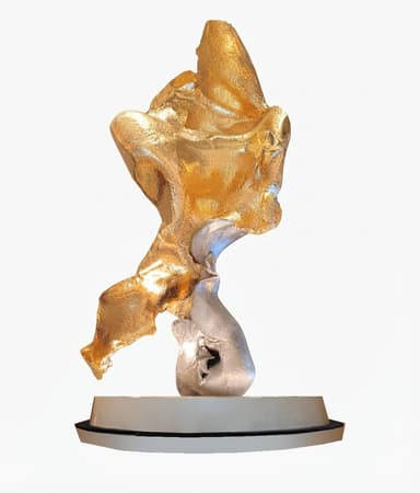 An abstract sculpture featuring a dynamic, fluid form composed of two distinct metallic elements: a larger, upper section with a rich gold-toned finish and a smaller, lower section in a contrasting silver tone. The piece is mounted on a simple, low-profile circular base. — 3D model