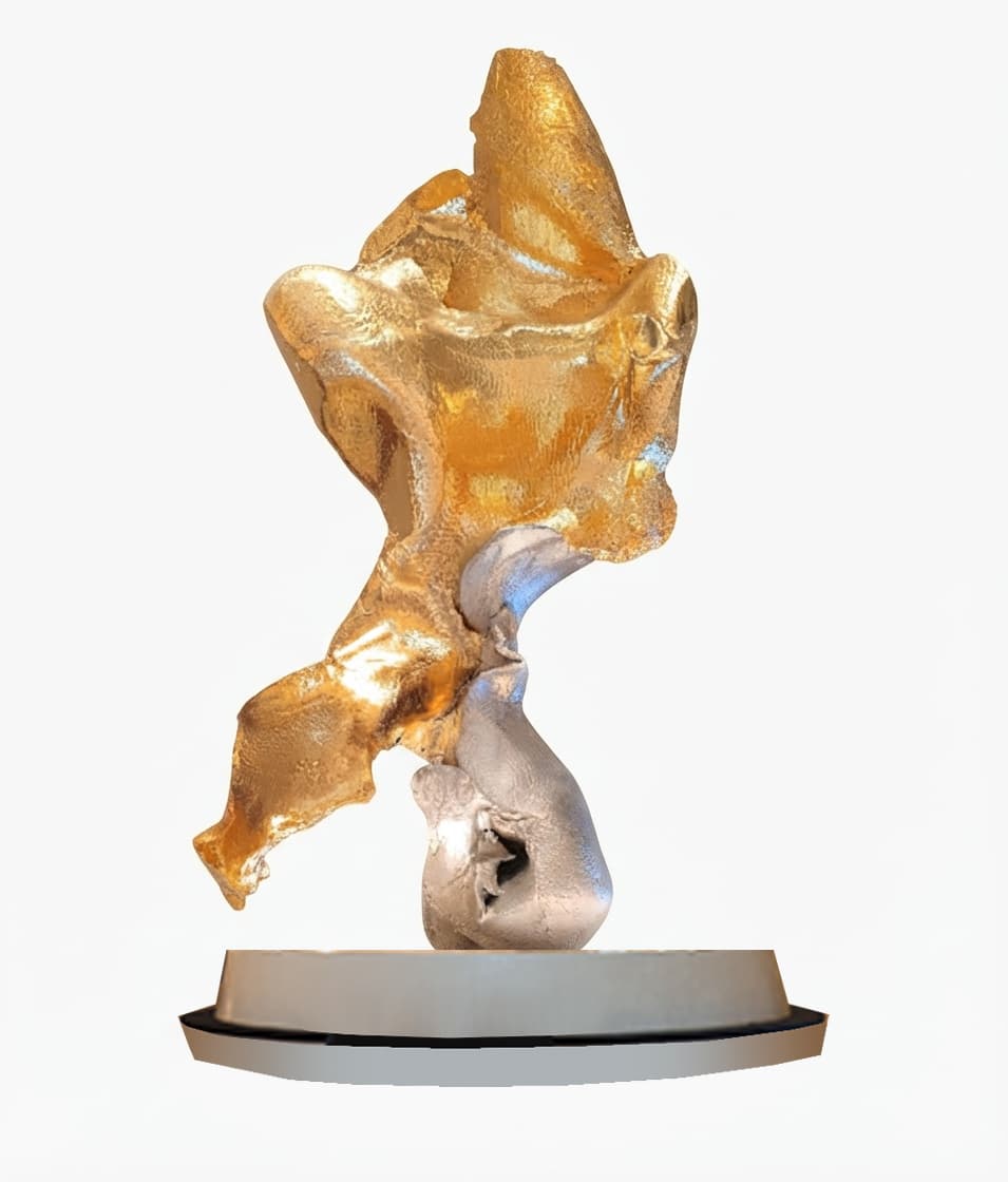 An abstract sculpture featuring a dynamic, fluid form composed of two distinct metallic elements: a larger, upper section with a rich gold-toned finish and a smaller, lower section in a contrasting silver tone. The piece is mounted on a simple, low-profile circular base. — 3D model