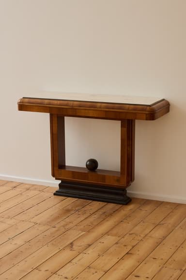 An elegant Art Deco console table featuring a rectangular white marble top and a solid walnut veneer base with a geometric, architectural form and a stepped plinth. — 3D model