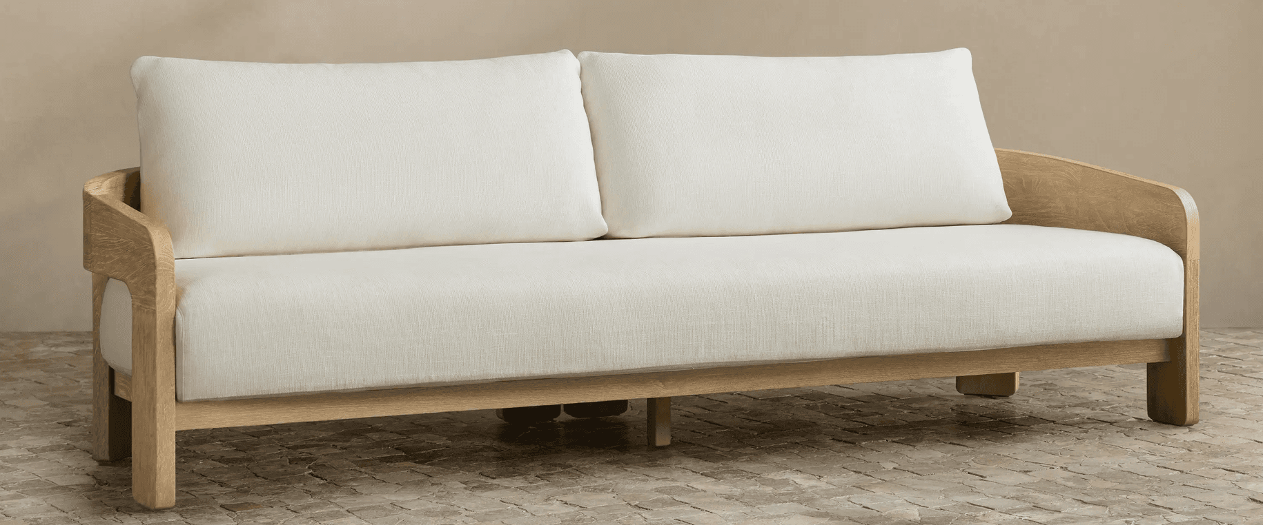A two-seater loveseat featuring a distinct exposed wooden frame made of light-toned oak. It is upholstered with off-white fabric cushions for both the seat and back, providing a minimalist and contemporary aesthetic. The armrests are integrated into the curved wooden frame, presenting a clean, open design. — 3D model