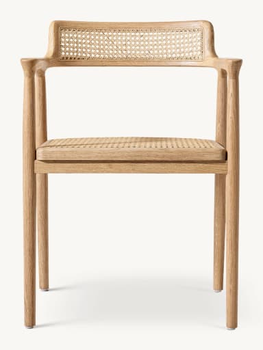 A modern dining armchair crafted from light-colored solid oak wood with natural cane weaving on both the backrest and the seat. The chair features a minimalist frame with rounded edges, integrated armrests that flow from the backrest, and four straight, tapered legs. — 3D model