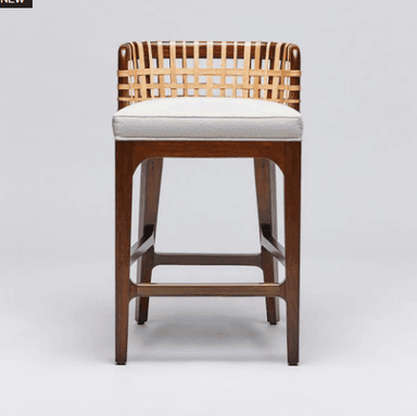 A modern bar stool with a wooden frame and a woven backrest. The seat is upholstered in a light-colored fabric. The stool has a tall profile, suitable for bar height counters. — 3D model