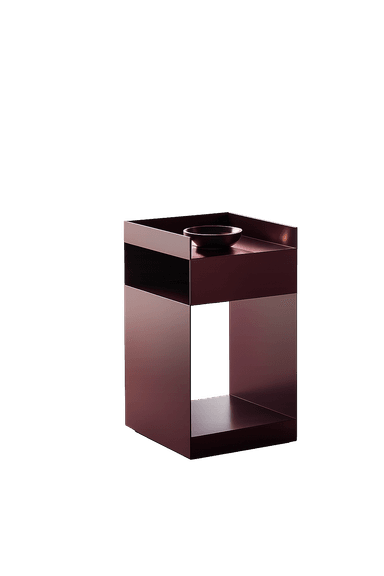A contemporary side table crafted from metallic material, featuring a dark reddish-purple hue and a minimalist, geometric form. It consists of a top surface with a raised lip on three sides, a central open compartment, and a solid base. A small dark bowl rests on the top surface. — 3D model
