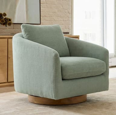 An upholstered swivel accent chair with a rounded barrel-shaped silhouette, light sage green fabric, and a natural wooden swivel base. — 3D model