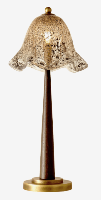 A transitional style table lamp featuring a dark tapered wood stem, a circular brass base, and a bell-shaped glass shade with a speckled, antique-gold finish. A small brass finial tops the lamp. — 3D model