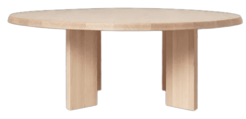 A light-colored, circular solid wood table with a thick top and two sturdy, flat plank-style legs. The wood appears to be natural, possibly pine or birch, with visible grain and a light, unfinished or lightly finished tone. The design is minimalist and contemporary, emphasizing natural materials and simple, robust forms. The legs are positioned asymmetrically to support the circular tabletop. — 3D model