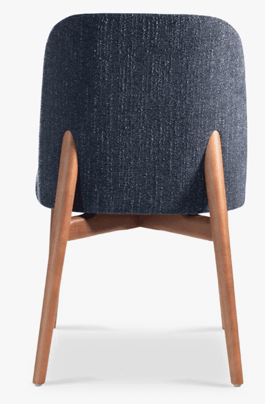 A modern dining chair with a curved backrest and upholstered seat and back. The chair has a wooden frame with four tapered legs. — 3D model