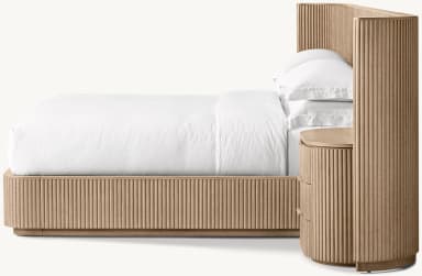 A contemporary wooden bed frame with an integrated headboard and side cabinets. The headboard is a large, vertically slatted panel that extends the full width of the bed and continues upwards. Attached to either side of the headboard are curved side panels. Built into the base of the bed frame and extending from underneath the headboard are two matching cabinets, each featuring three drawers with integrated pulls. The bed is dressed with white bedding, including two pillows. — 3D model