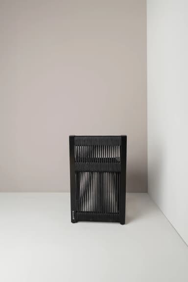 A contemporary chair with a black frame and a seat and backrest constructed from closely spaced black cords or ropes. The cords are stretched vertically across the frame, creating a textured and somewhat visually open surface. The legs are simple, straight, and square in profile. — 3D model