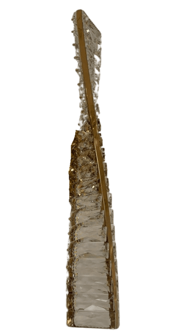 A vertical, wall-mounted lighting fixture featuring a polished gold-toned metal frame intricately embellished with numerous clear, faceted crystal elements. The crystals are arranged in a multi-tiered pattern along the central metal structure, designed to refract and reflect light. A rectangular gold-finished mounting plate is visible at the center. — 3D model
