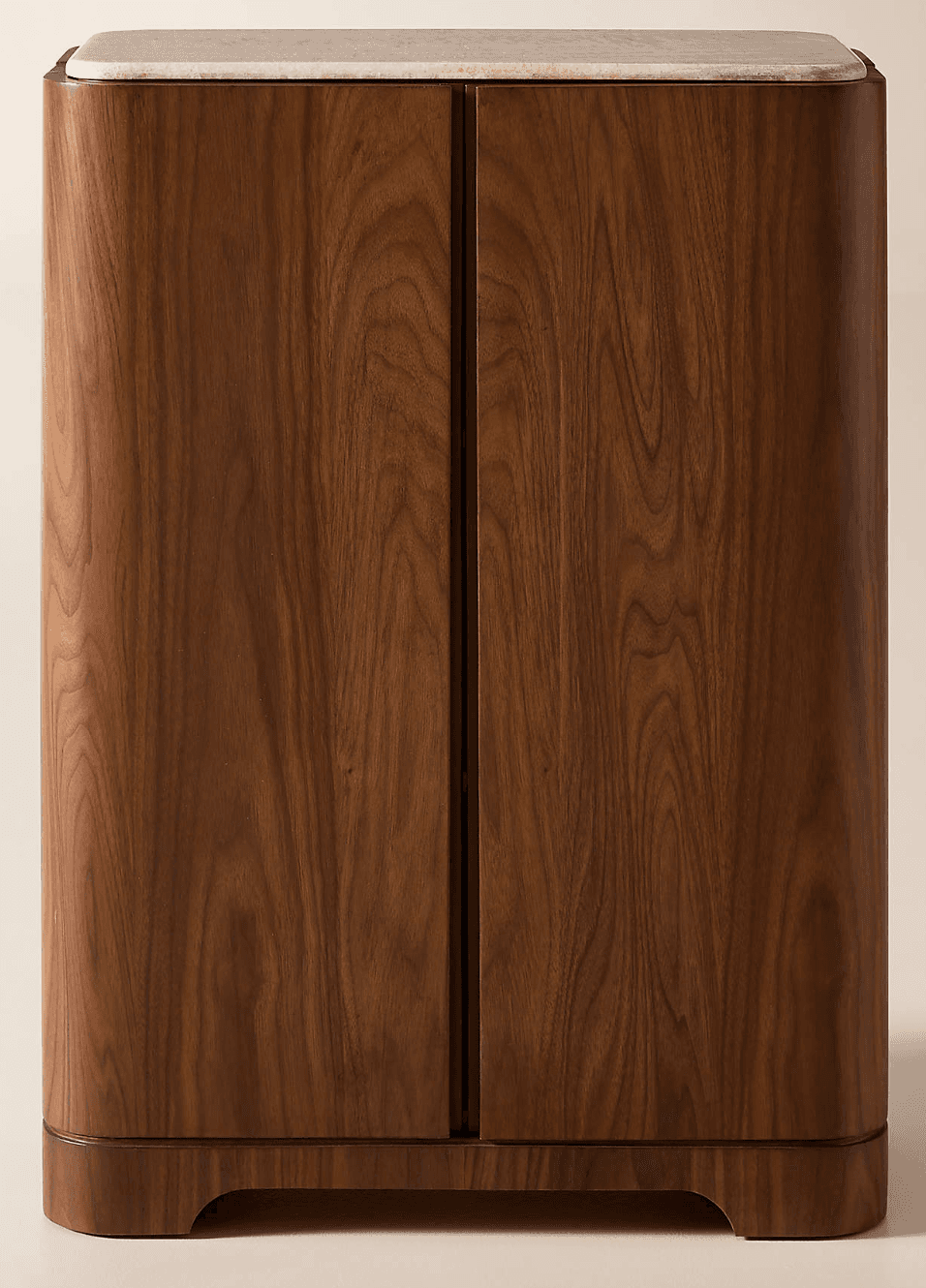 A tall, narrow storage cabinet featuring a rich dark wood finish, likely walnut, with elegantly rounded corners. The top surface is adorned with a light-colored, possibly beige or cream, marble slab. The front facade indicates two full-height doors, suggesting ample interior storage. The cabinet stands on a subtle, recessed plinth base. — 3D model