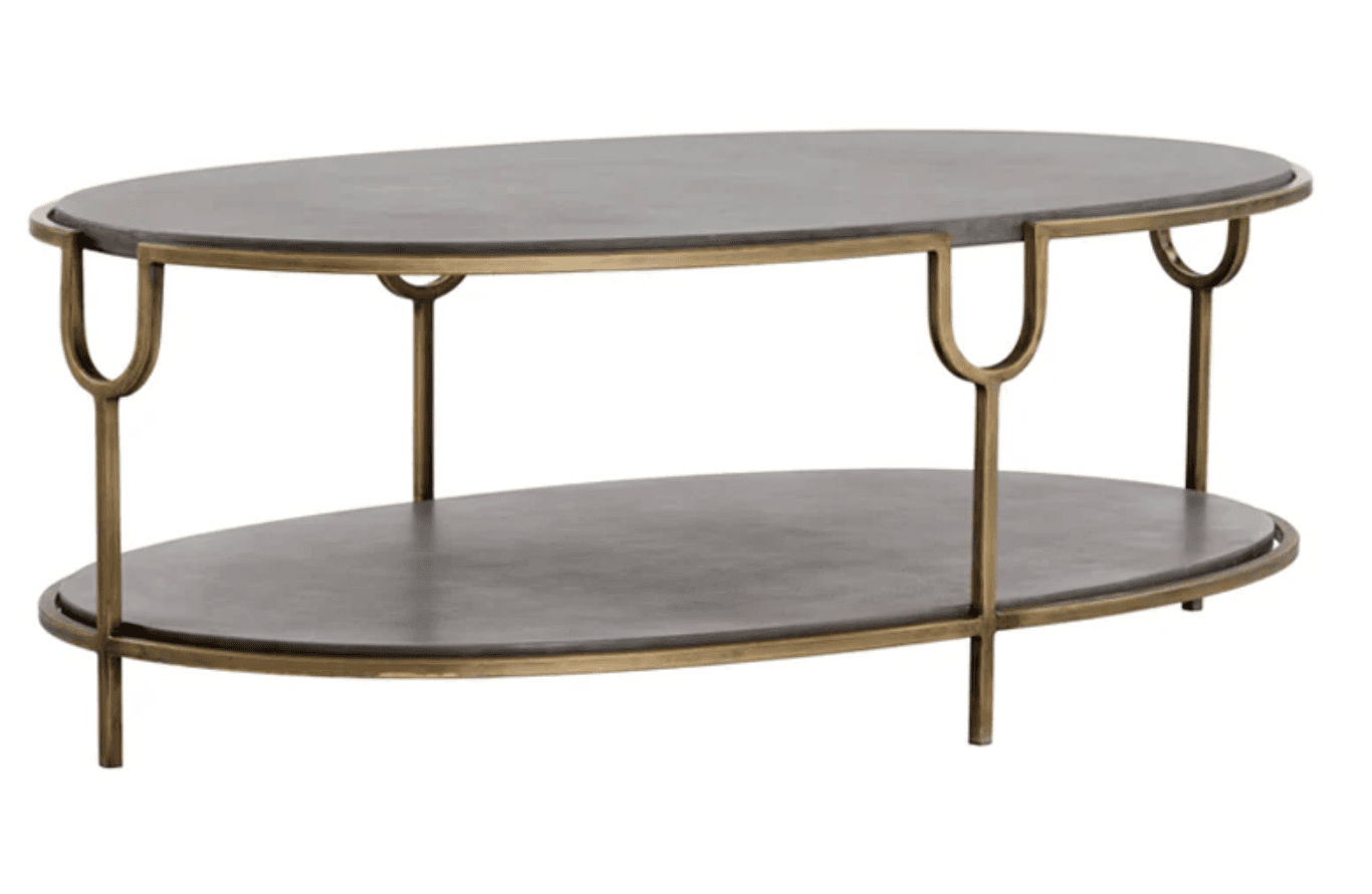 A two-tiered coffee table with an oval shape. The table features dark-colored, presumably stone or composite, surfaces for both the top and lower shelves. The frame and legs are constructed from metal, exhibiting a brass or antique gold finish. The design of the legs includes a distinct U-shaped element where they connect to the tabletop. — 3D model