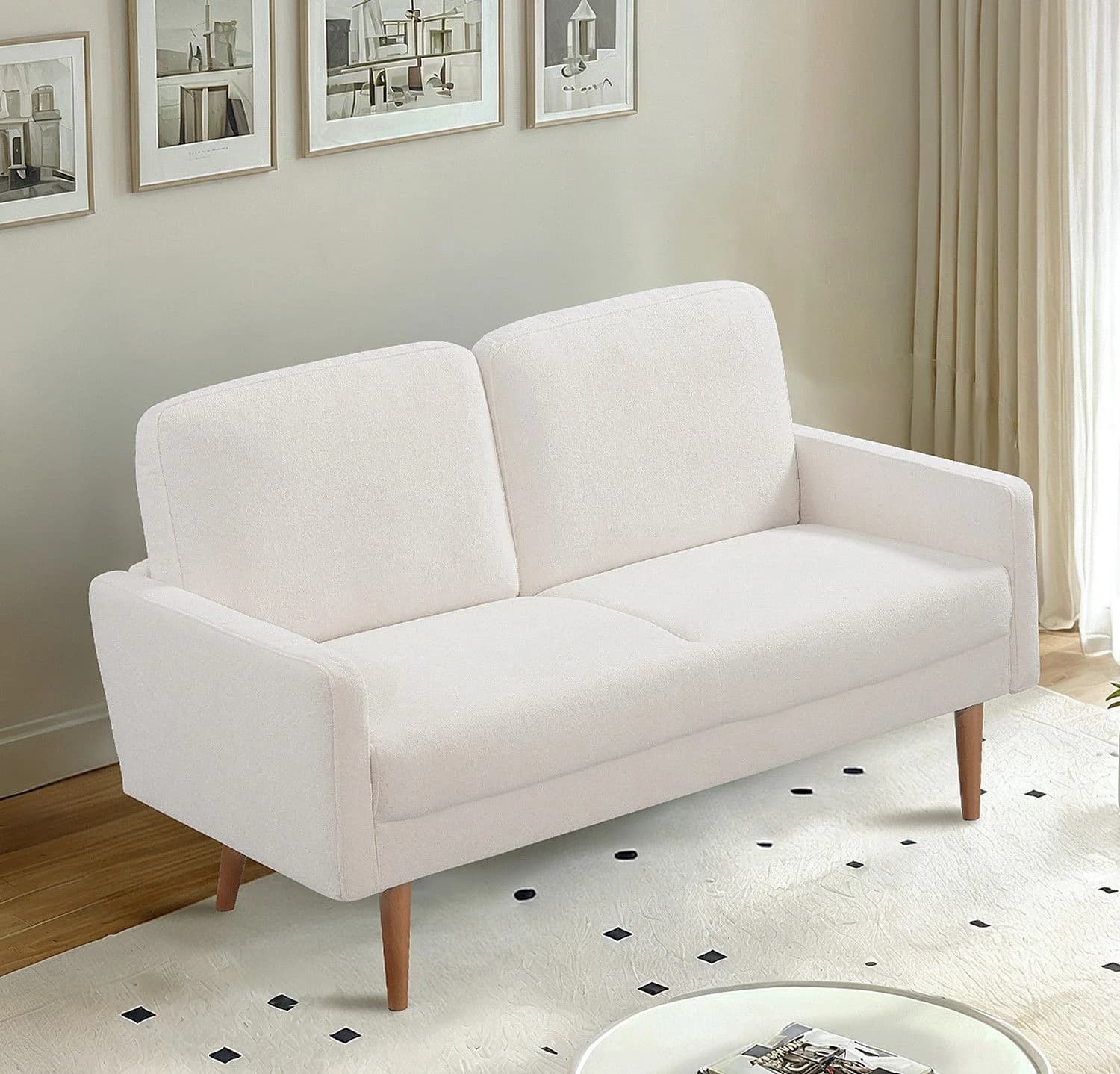 A two-seater sofa with a simple, modern design. It features a plush, upholstered seat and backrest, with gently sloped armrests. The sofa is supported by four tapered wooden legs, angled outwards. The upholstery appears to be a textured fabric in a light neutral color. — 3D model