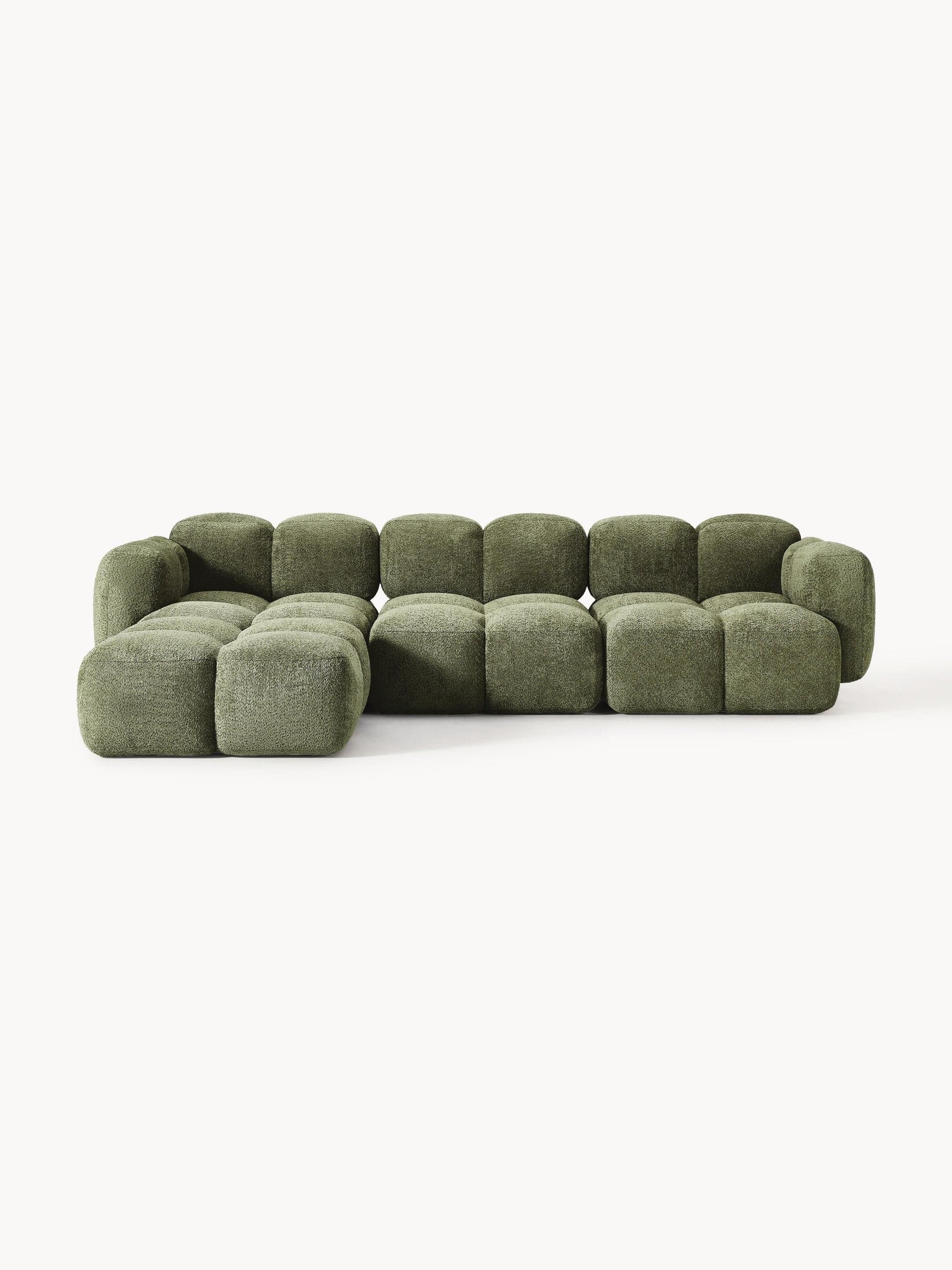 A modular sectional sofa with a low profile. The sofa is composed of individual cubic modules with rounded edges, upholstered in a textured, short-pile fabric. It features a chaise lounge section on the left. The overall design is contemporary and has a soft, inviting appearance. — 3D model