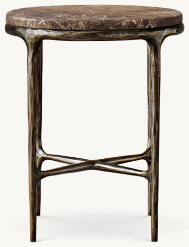 A small, round table featuring a dark brown marble top with prominent lighter veining. The top rests on a robust, textured dark cast metal base with an organic, sculptural design. The base consists of four splayed legs connected by an X-shaped stretcher near the floor. — 3D model