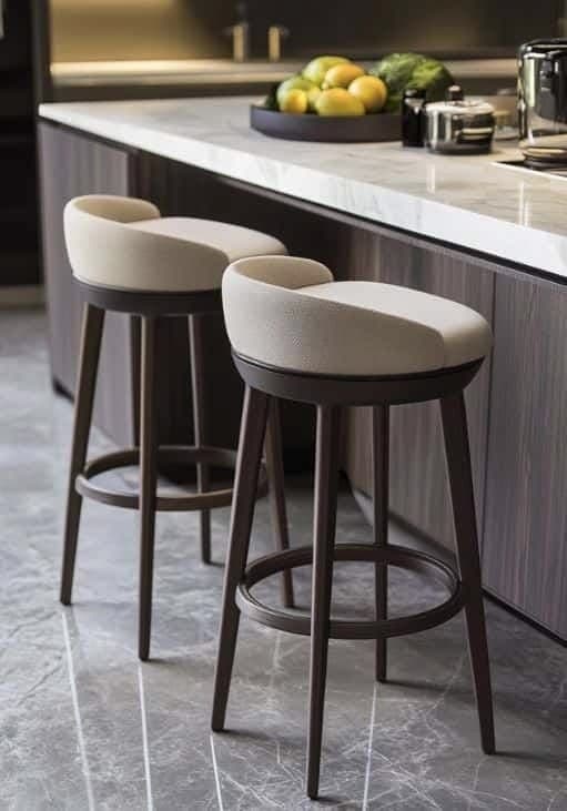 A modern bar stool featuring a light beige upholstered seat and a low, curved backrest, set atop a dark brown wooden frame with tapered legs and a circular footrest. — 3D model