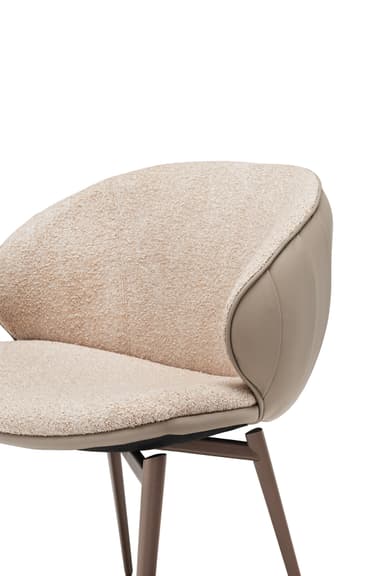 A modern armchair with a curved back and seat, upholstered in textured beige fabric and smooth taupe leather. It features a swivel base supported by four slender, angled legs in a dark metallic finish. — 3D model