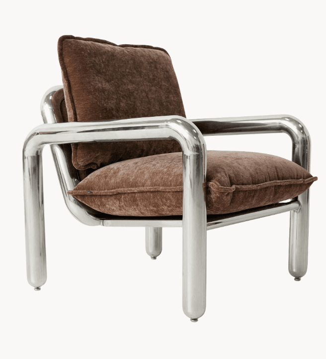 A contemporary lounge chair featuring a polished tubular chrome frame and deep brown, plush velvet cushions. The frame forms a continuous, rounded structure for the arms and back, with matching tubular legs. — 3D model